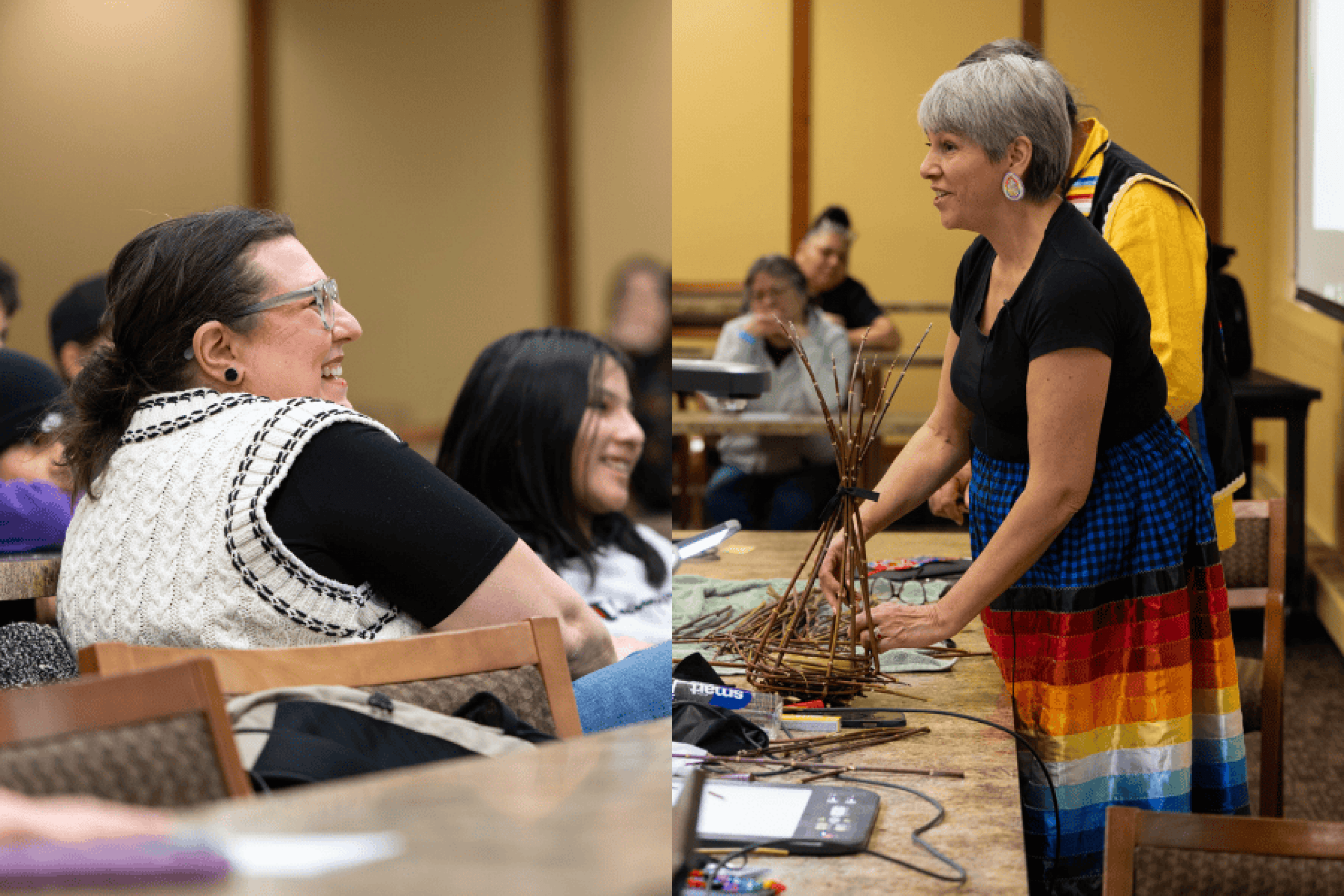 People seated and smiling in a classroom, while another person weaves a basket from thin branches on a table.