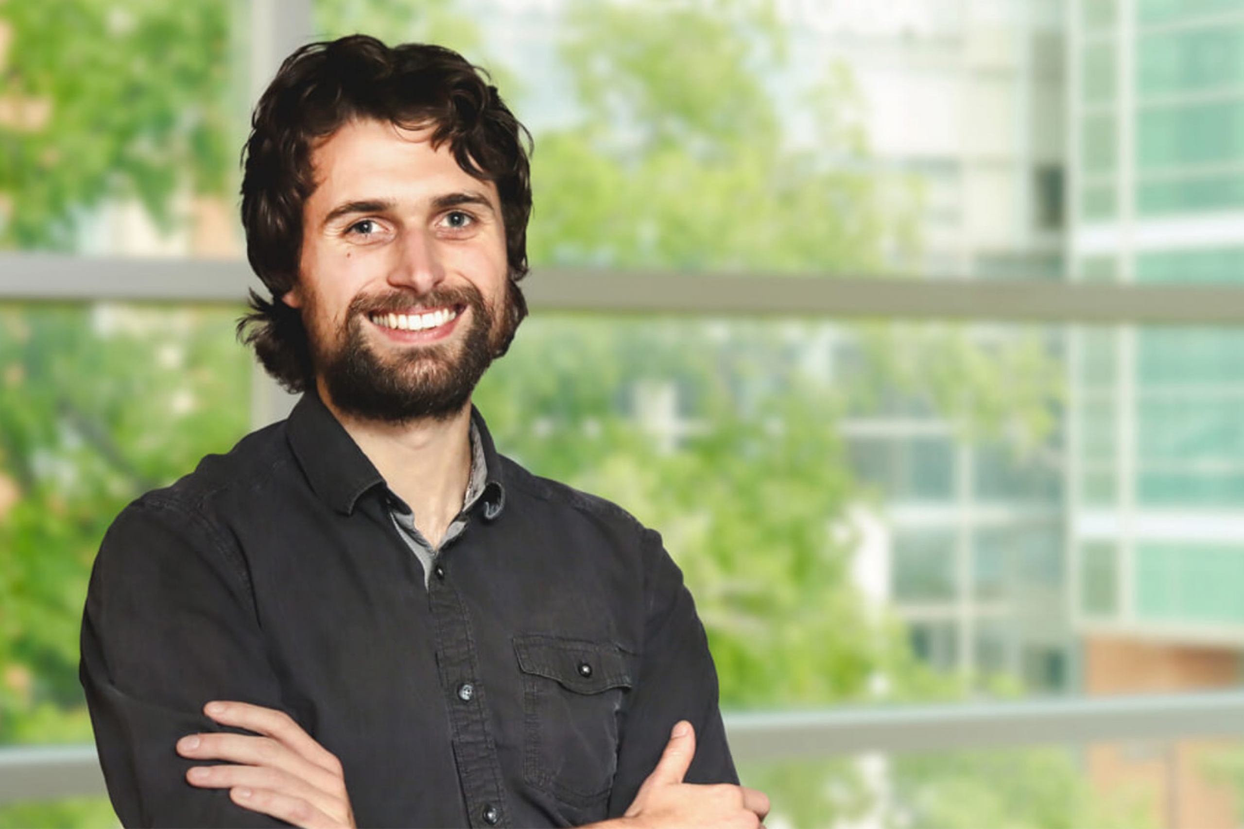 Fabian Rohden wearing a black button down shirt and smiling at the camera.