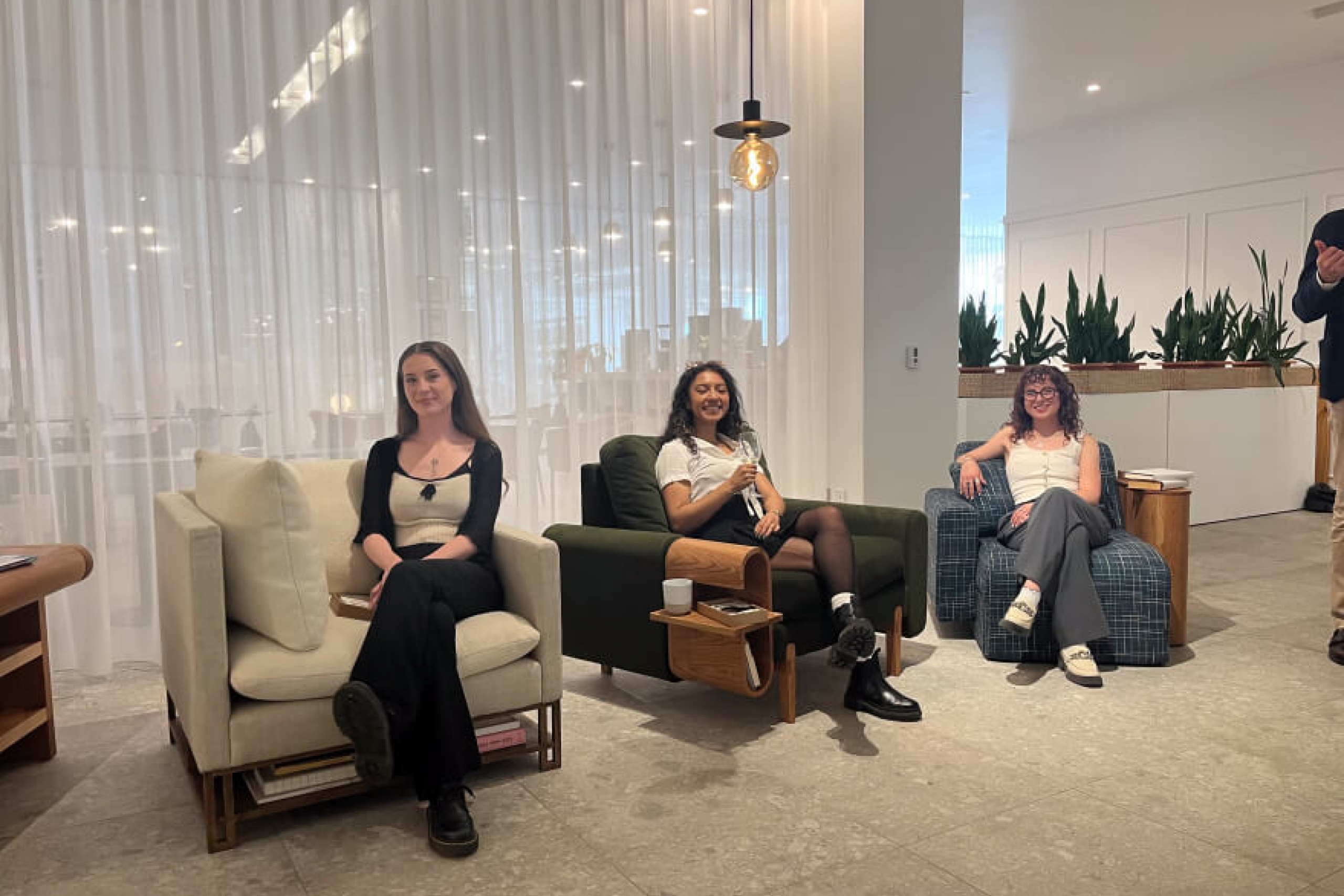 Students sit on their completed chairs on display at the EQ3 store.