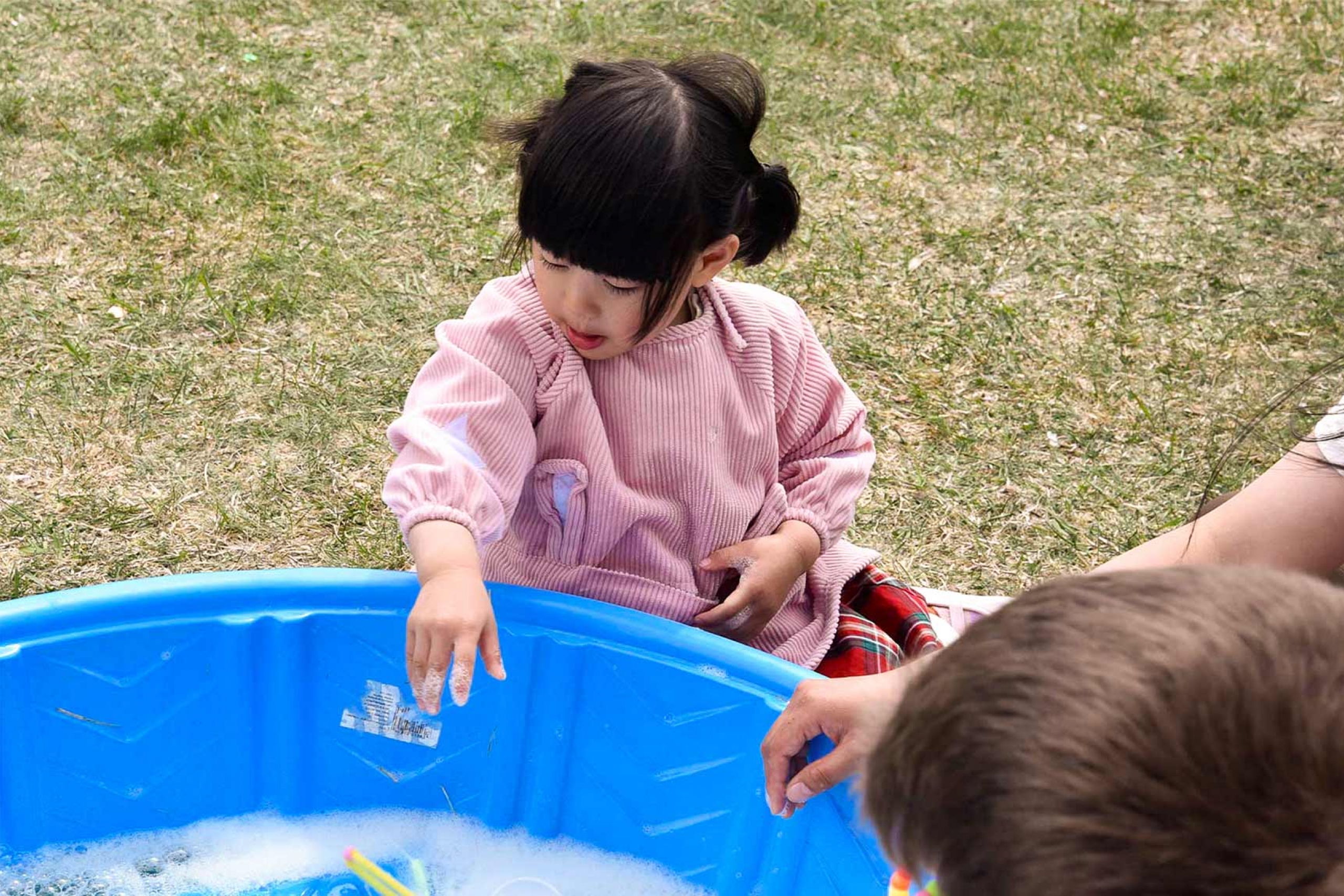 A kid playing with bubbles.