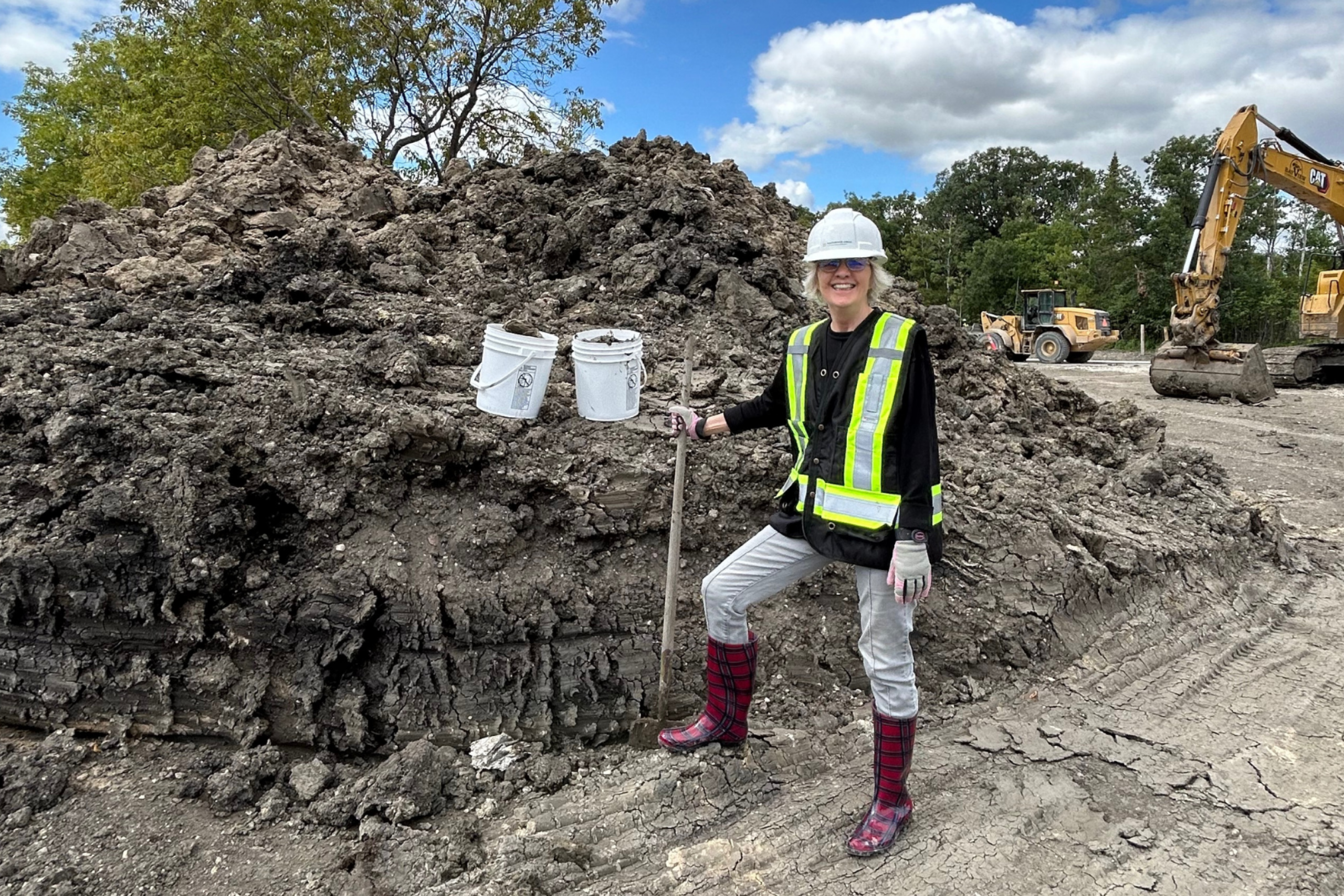 Grace Nickel collects local clay at the Southwood Circle construction site.