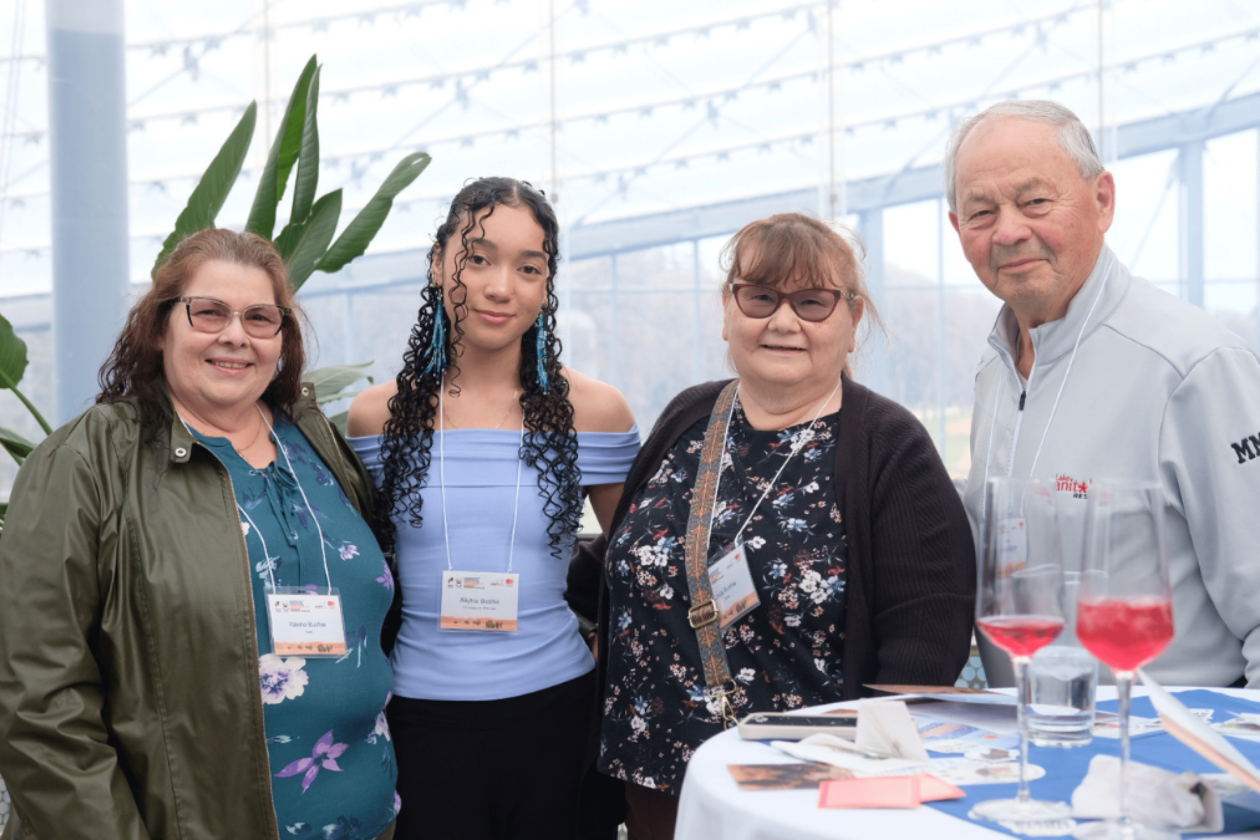 Aliyhia Bushie stands with three older adults at 2025 ICE gathering event.