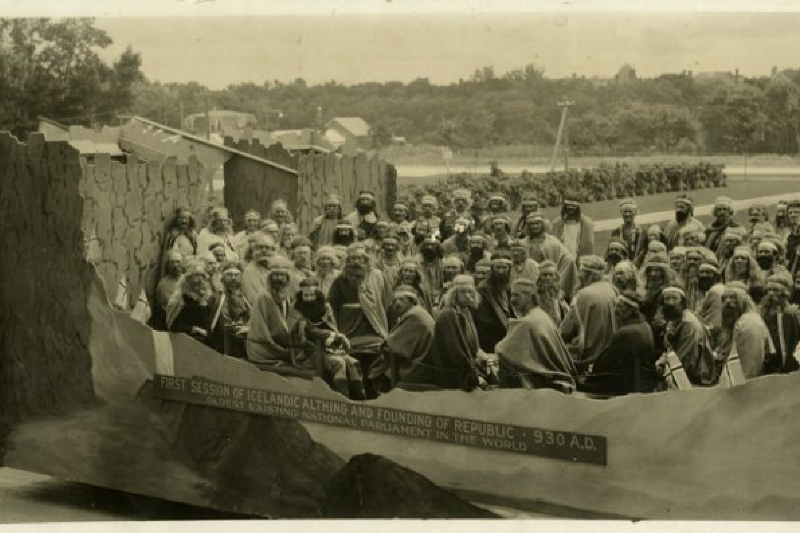 A bunch of people in a boat replica being pulled by horses