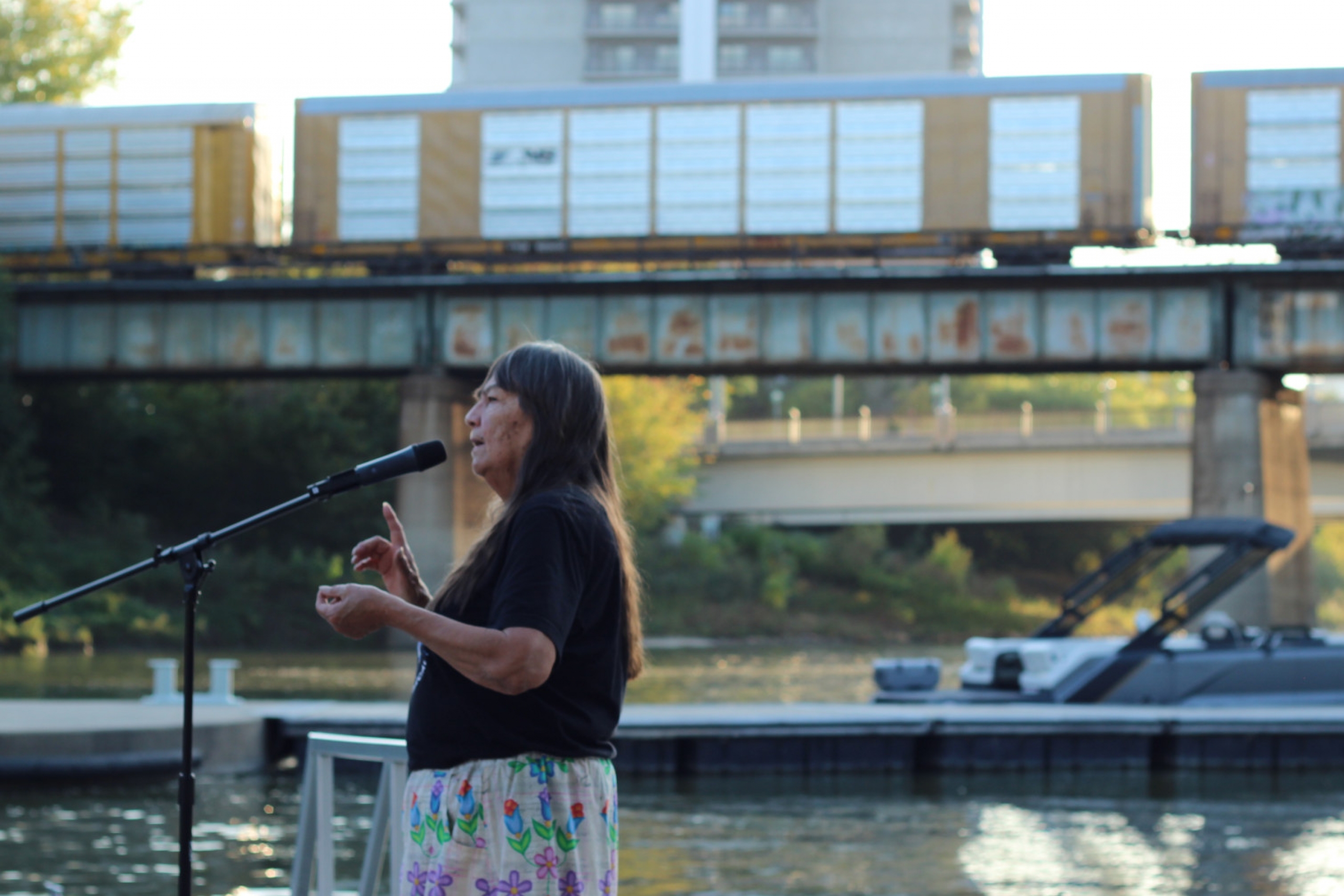 Dr. Kathy Bird standing in front of the Assiniboine River at The Forks.