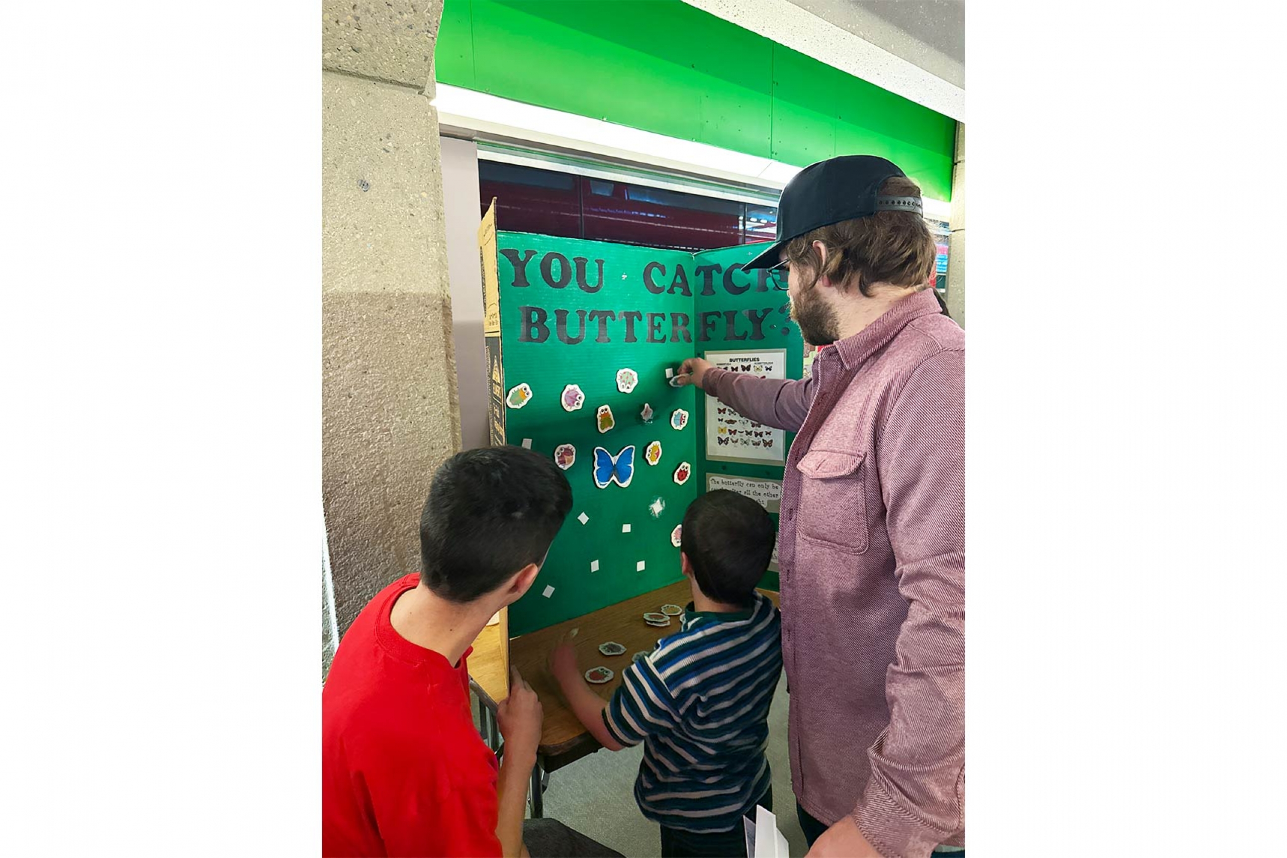 Adults and kids participating in the Math Mania booth.