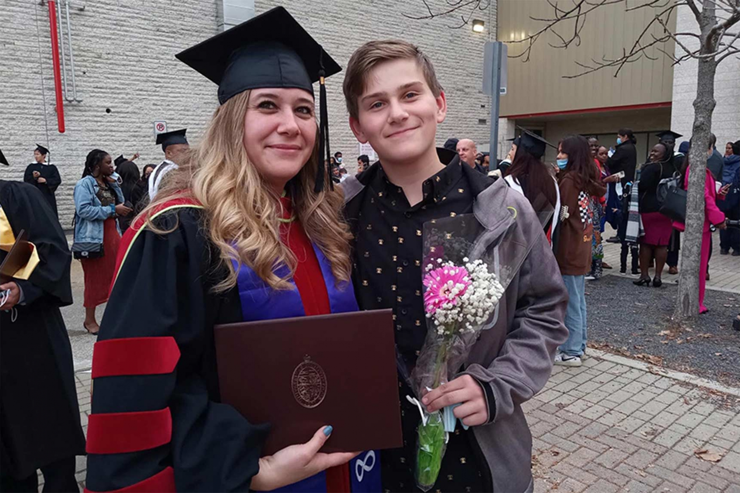 Melanie Lalonde with her son during her phd graduation.