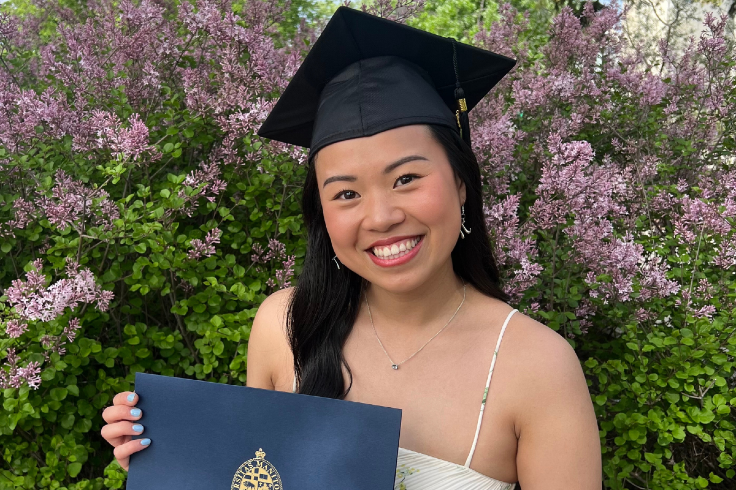 female student with grad cap holding diploma