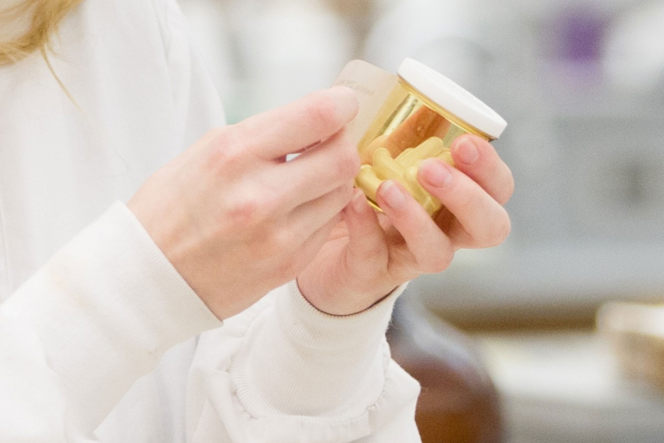 Patient holding a prescription bottle.