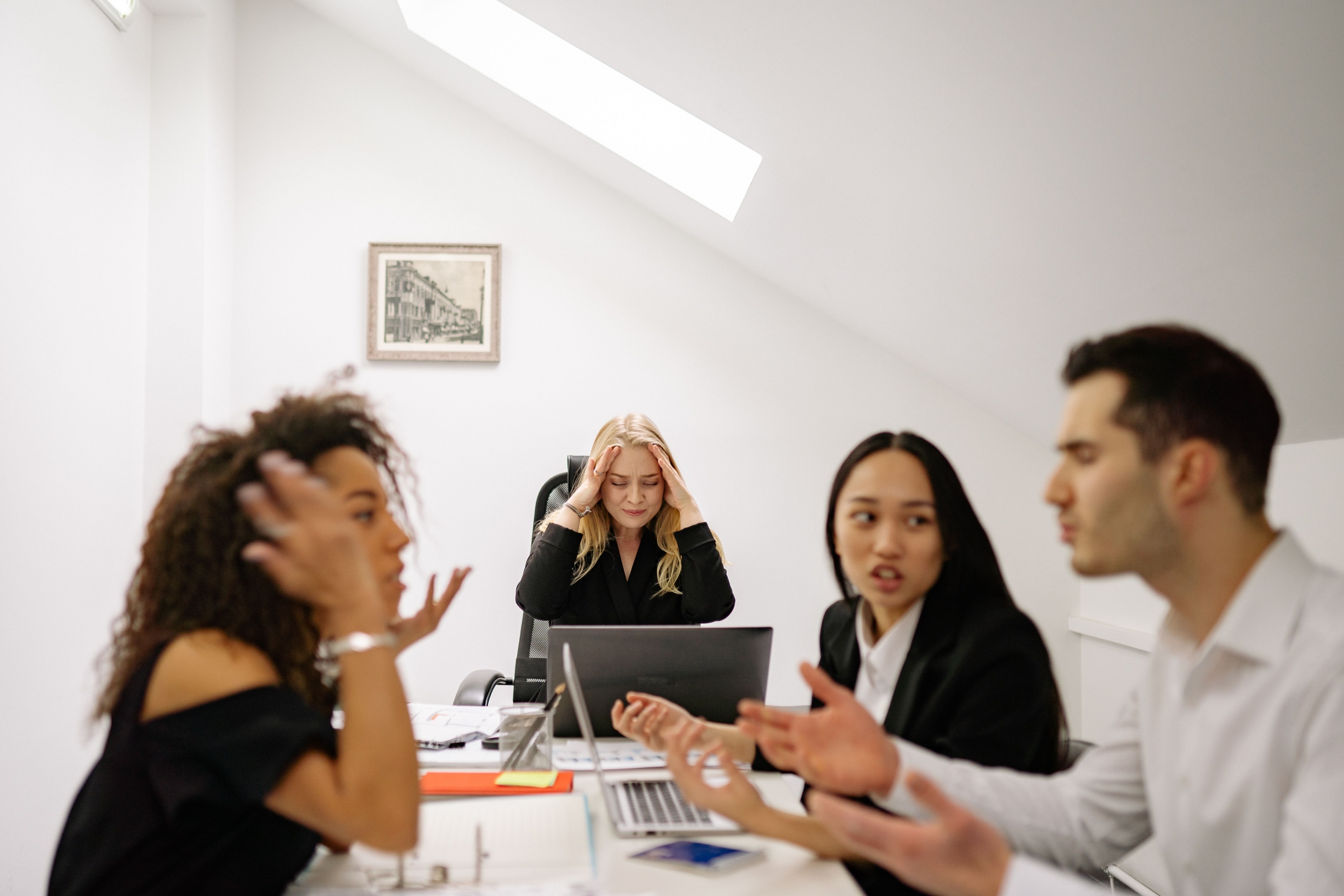 A group of people sitting at a table arguing 
