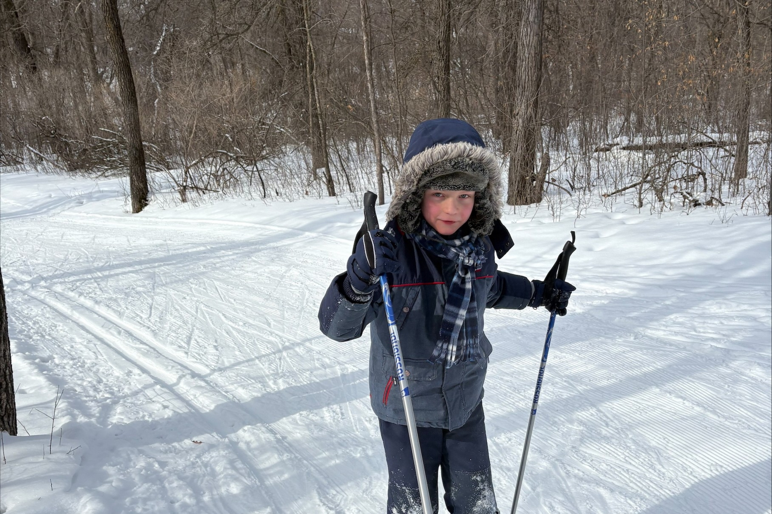 a young boy cross-country skis