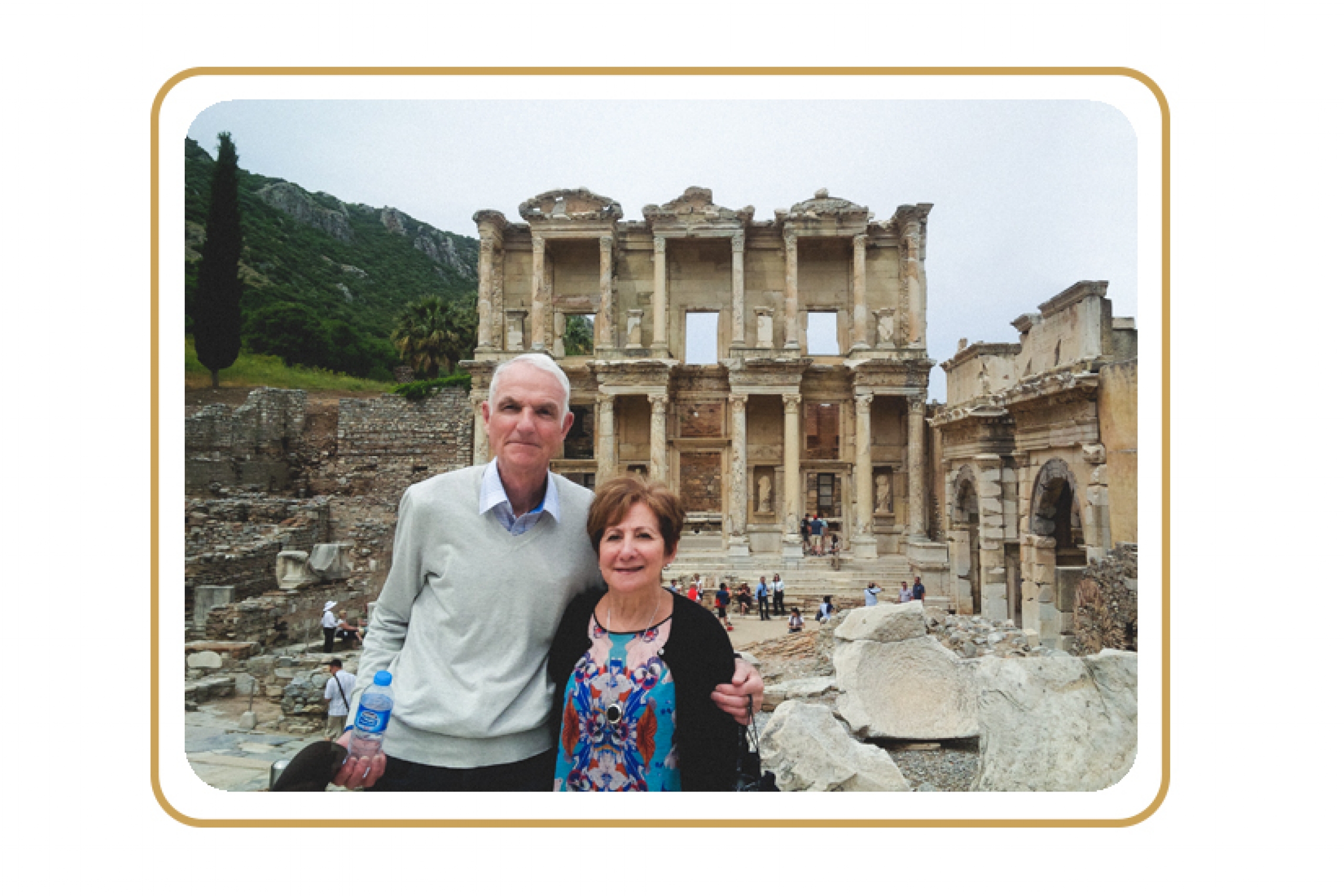 A couple, John and Nerina Robson, in posing in front of some ruins in Turkey.