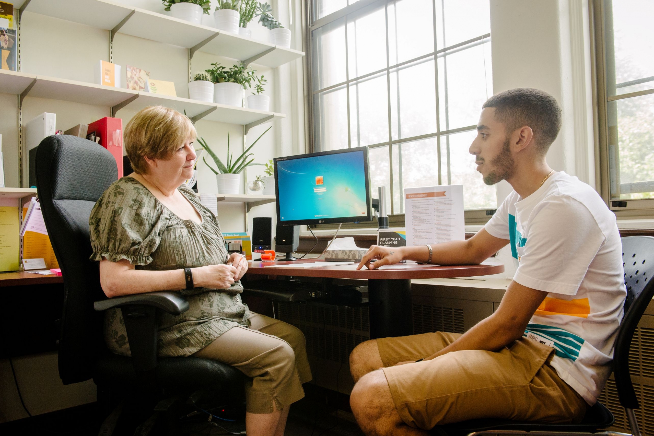 A student meets with a staff member to get support.