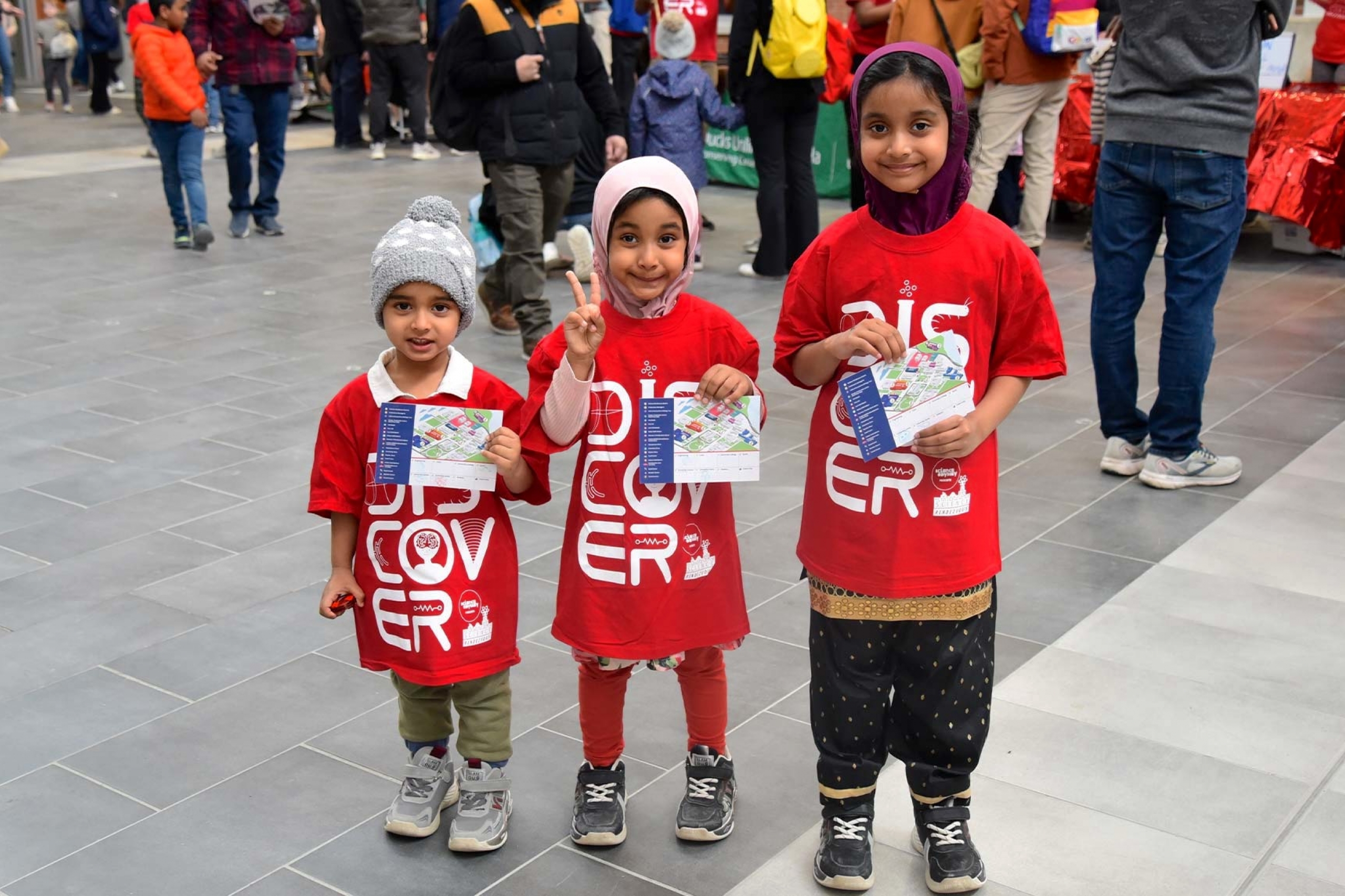 Three kids smiling at the camera during Science Rendezvous 2026.