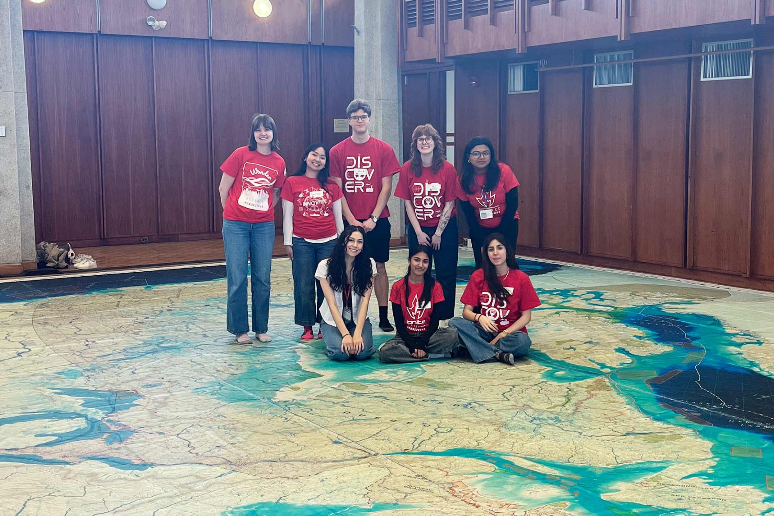Science Rendezvous volunteers standing on the giant map.