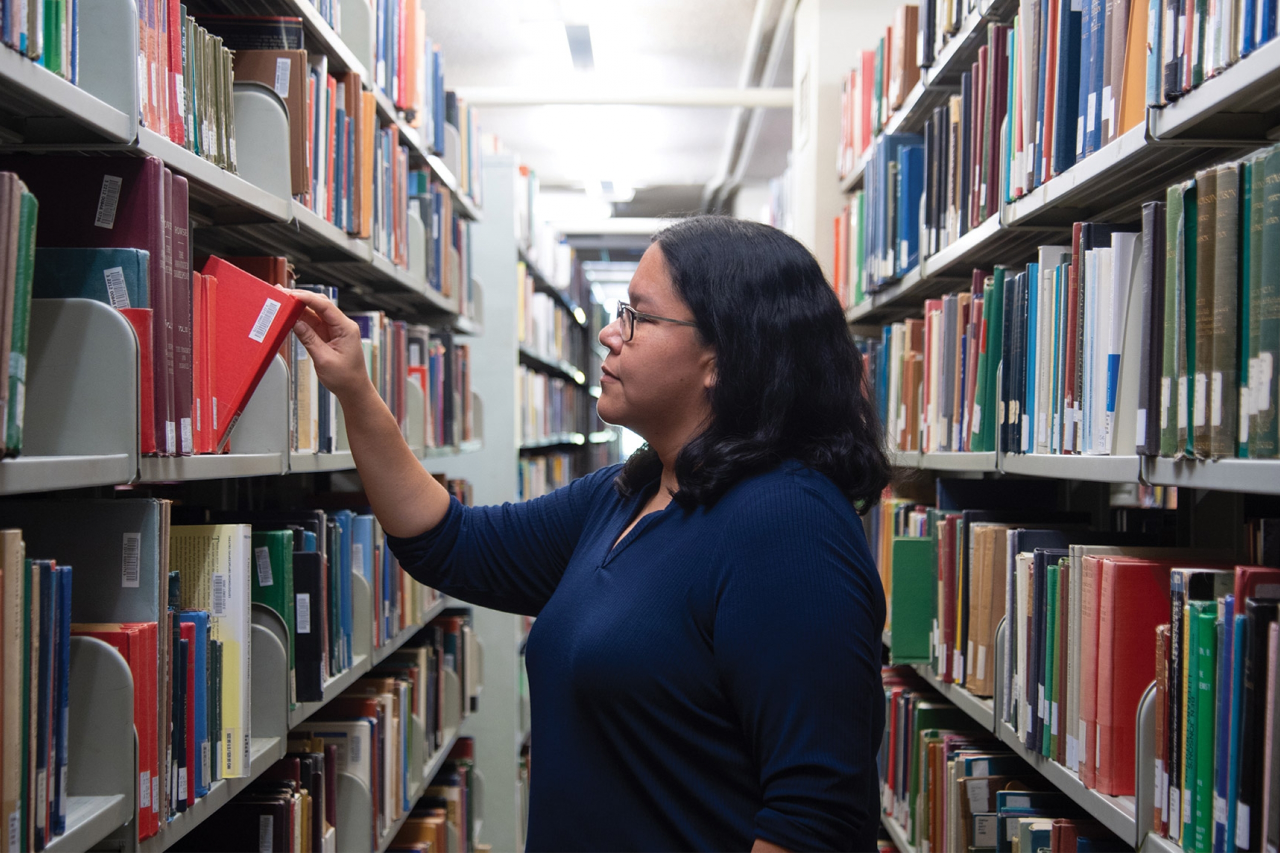 Shana looking at some books in the library.