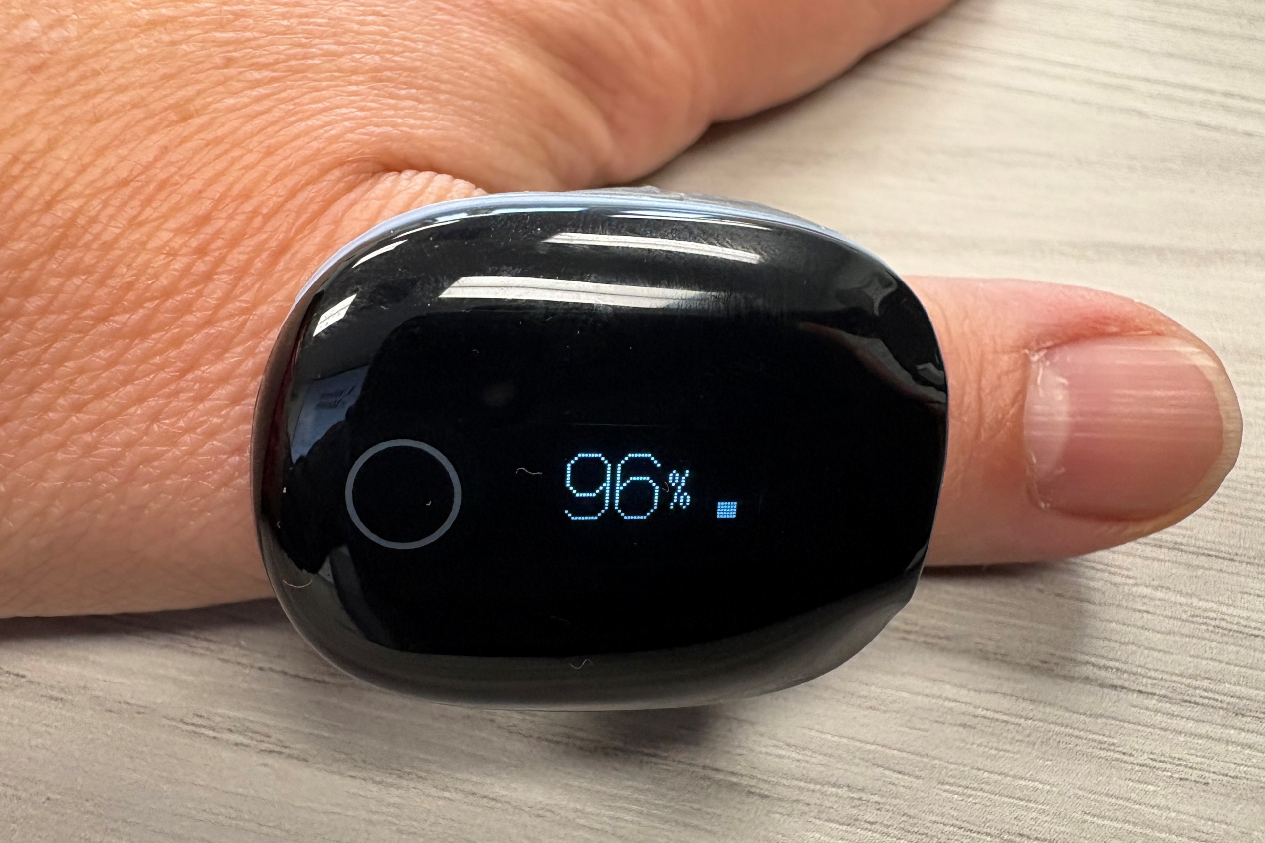 Close up of a digital screen worn as a ring on a person's thumb.