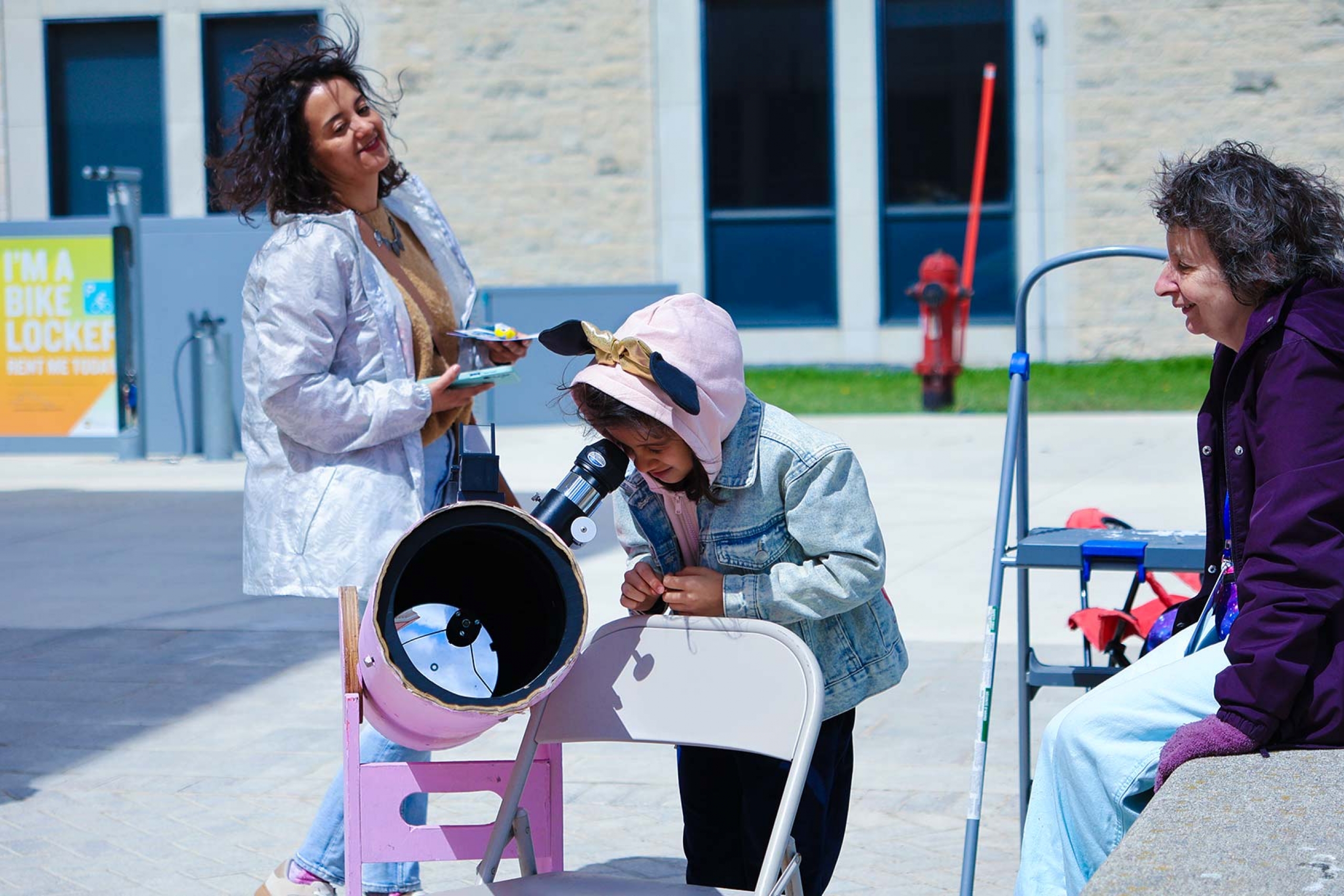 A kid looking through the telescope.