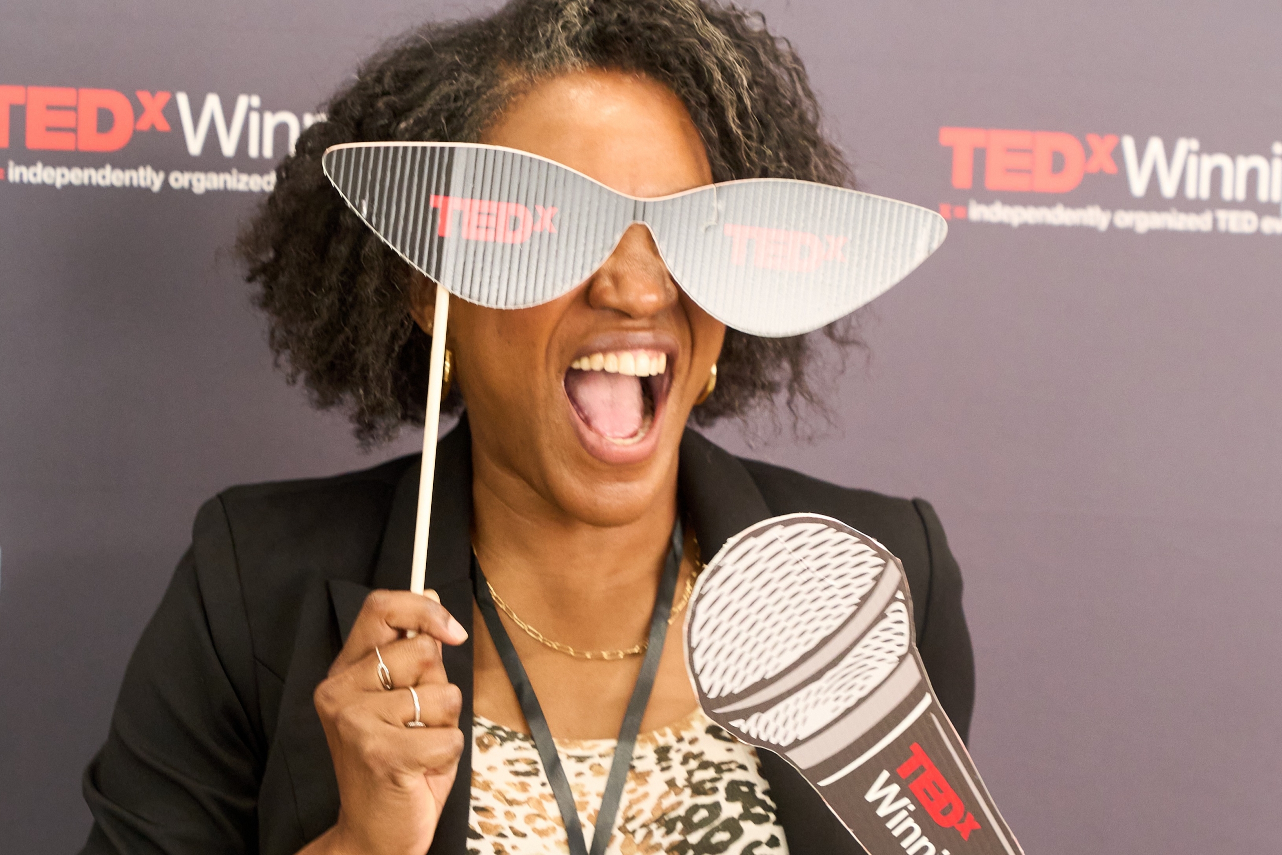 An excited attendee poses with TEDx props