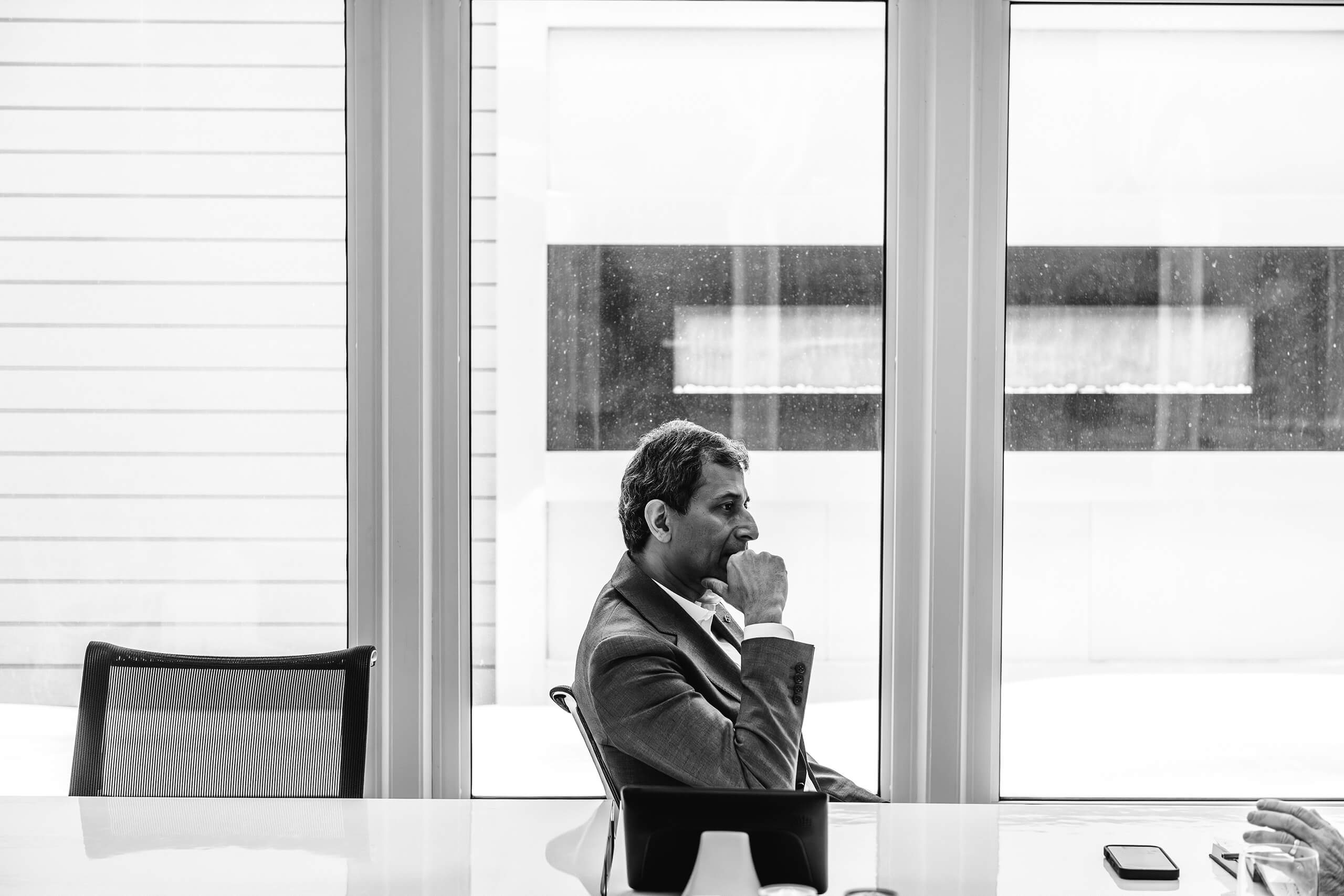 A profile of a man in front of a window