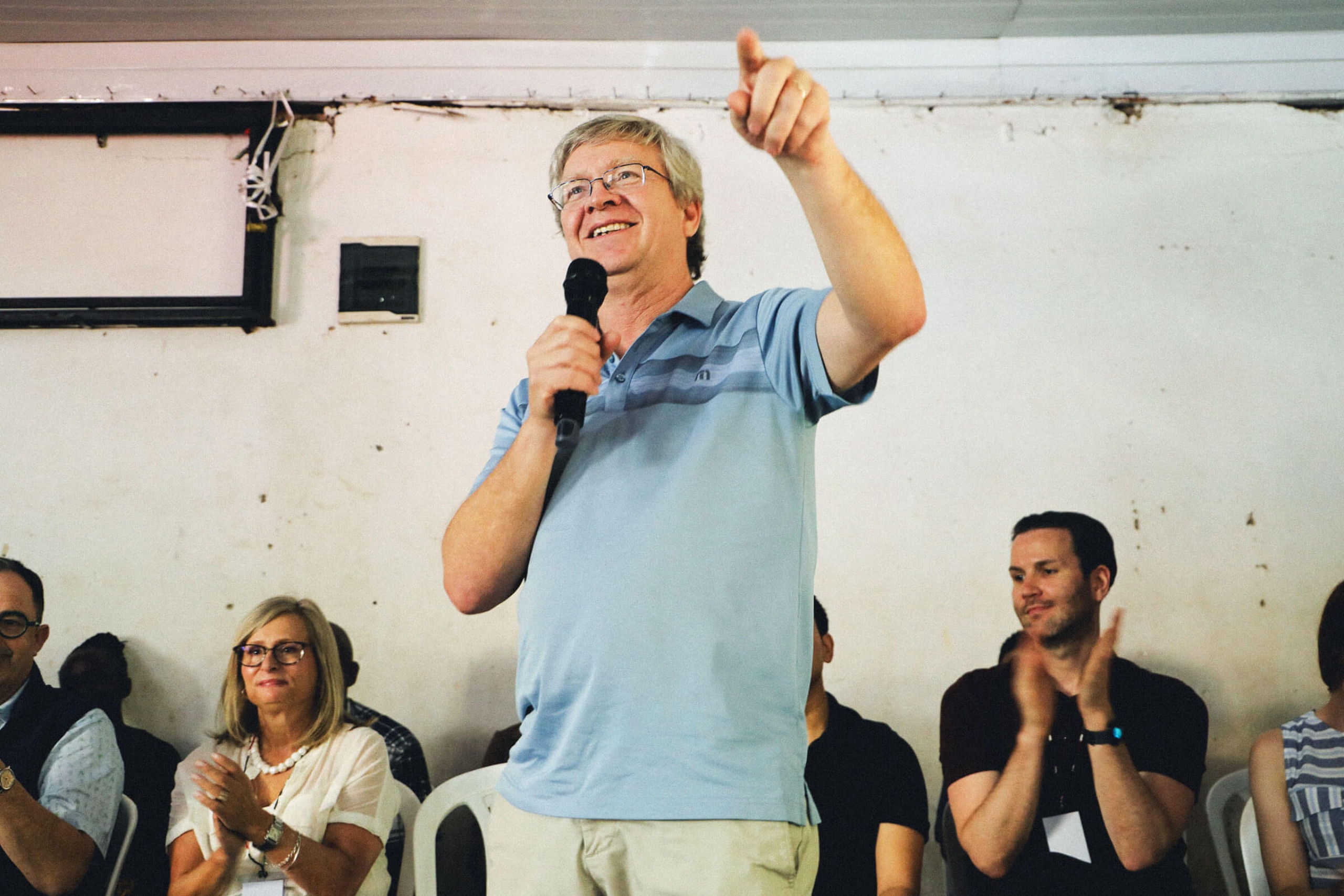 A man with a microphone addresses the crowd
