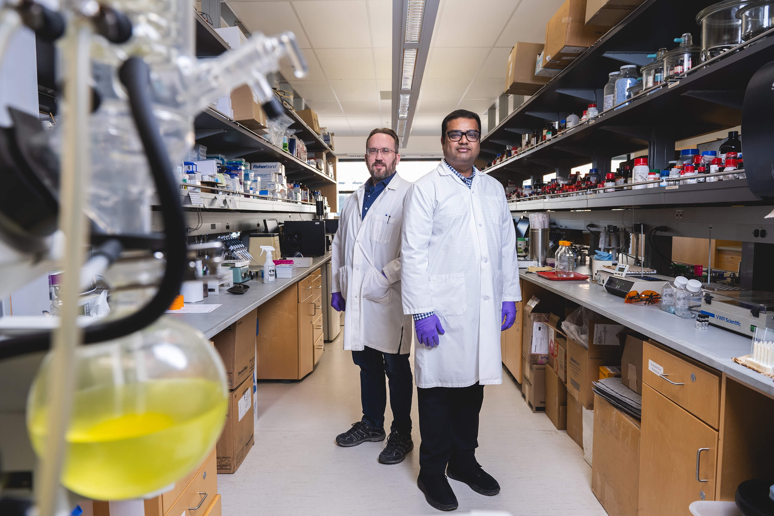 two men standing in a lab