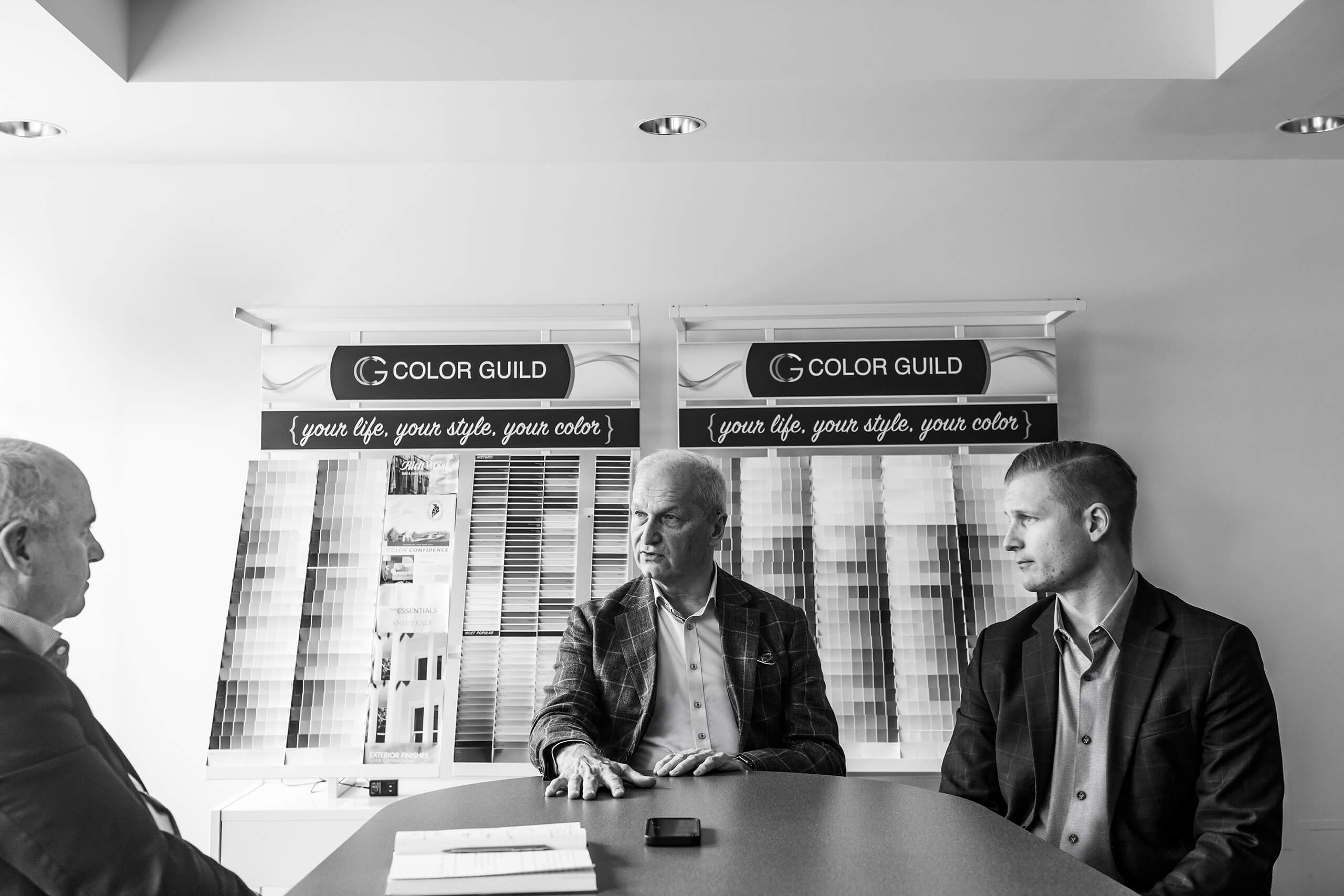 three men talking at a table