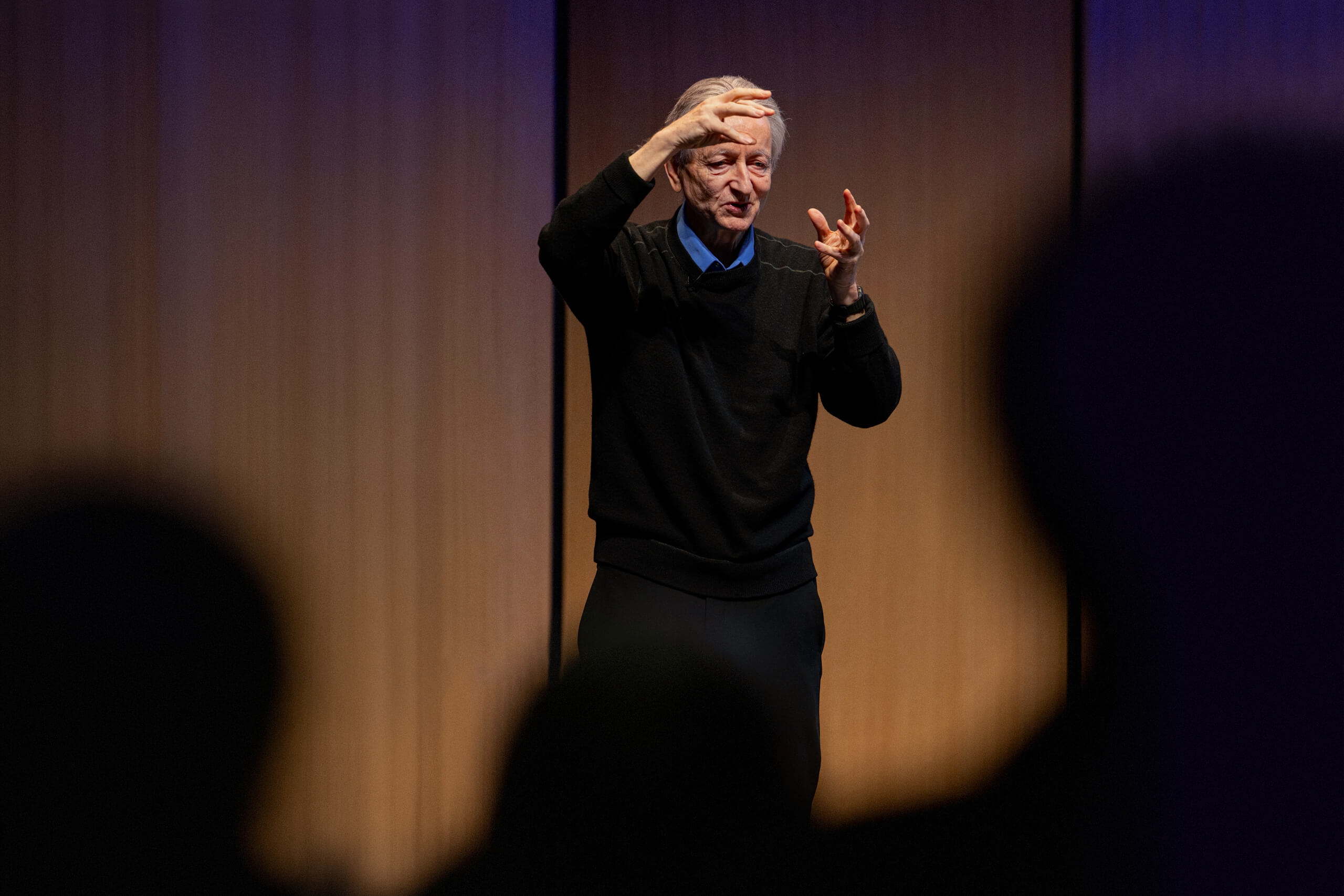 A man speaking on a stage