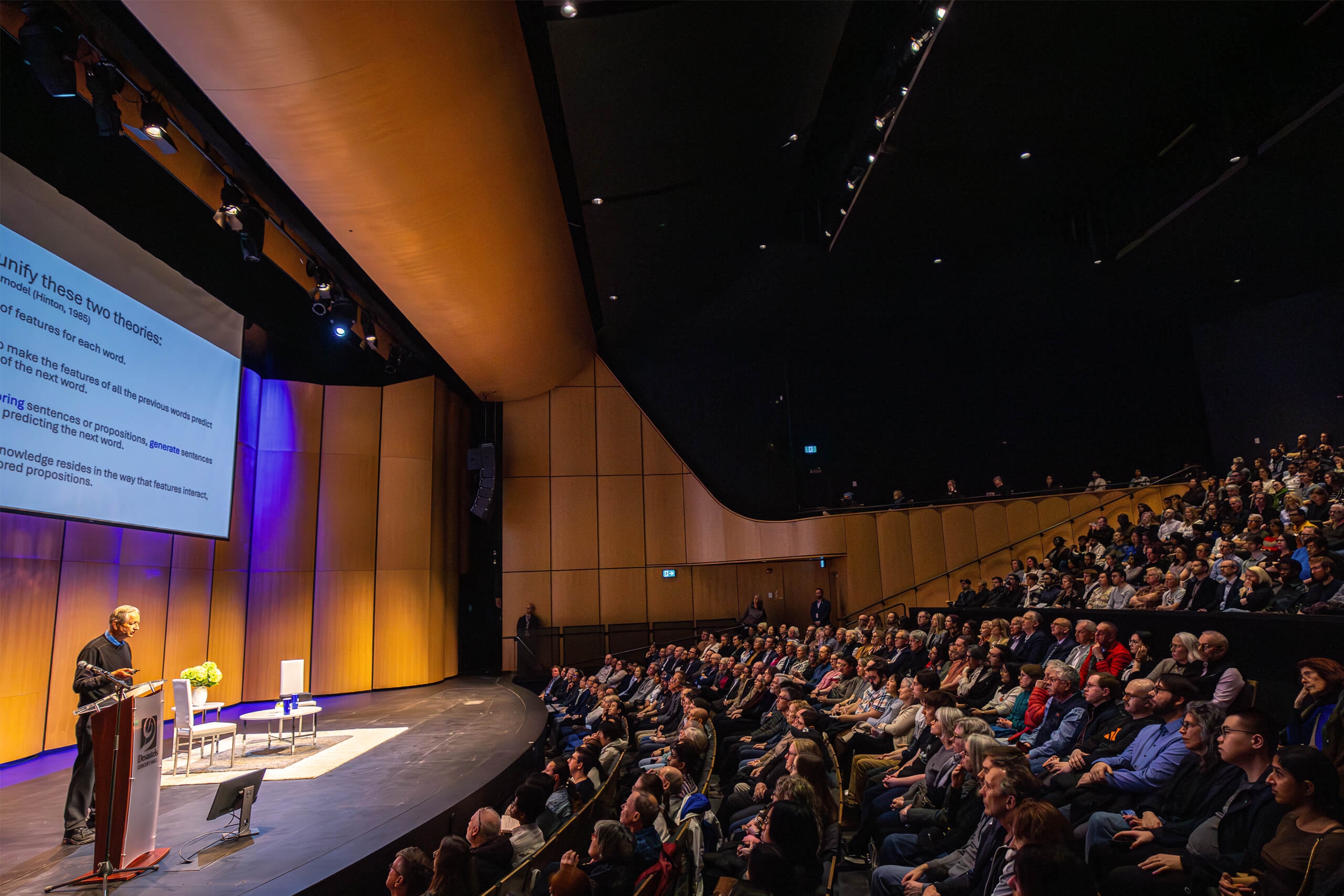 A man on a stage with an audience