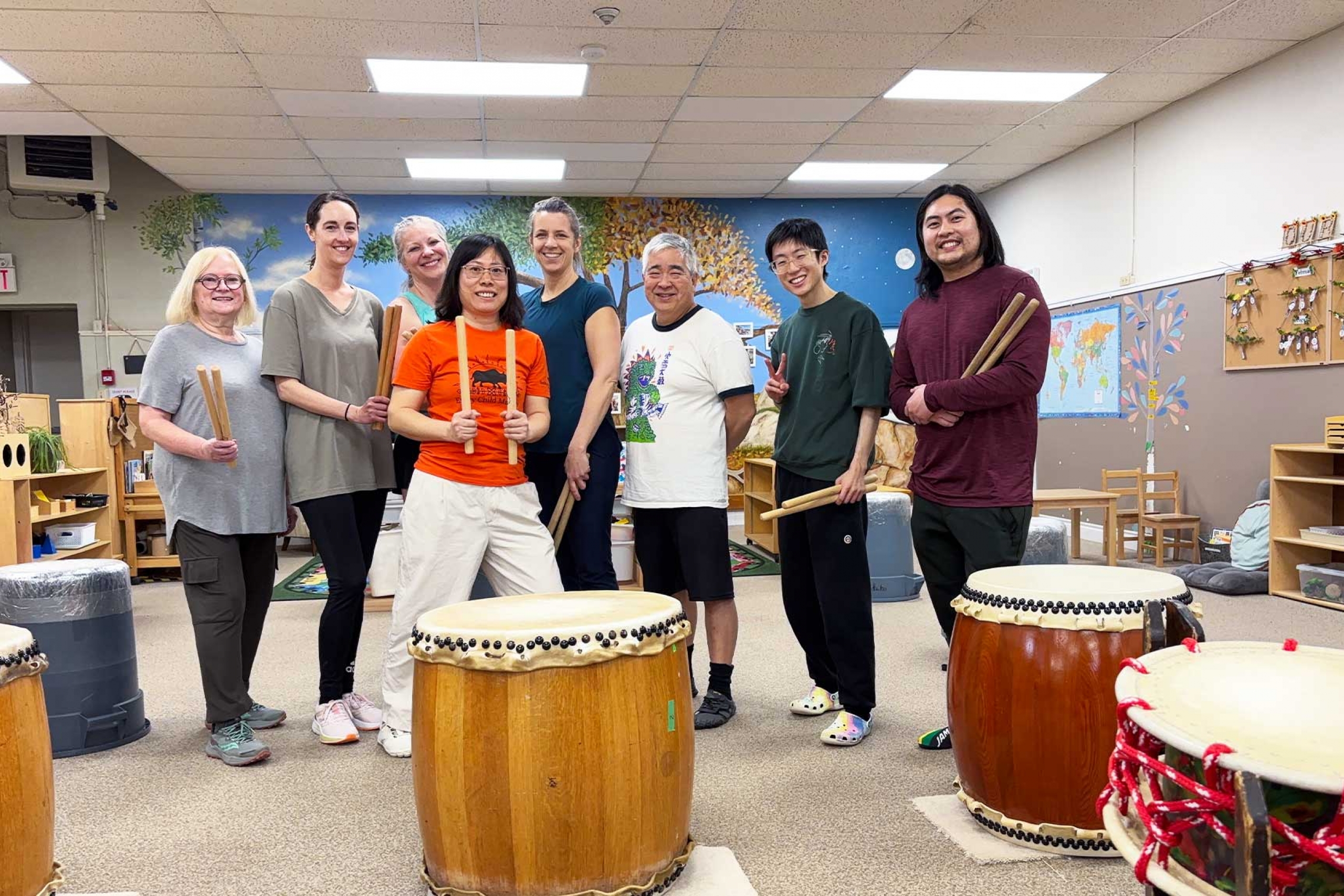 Xinli wang with her taiko drumming group.