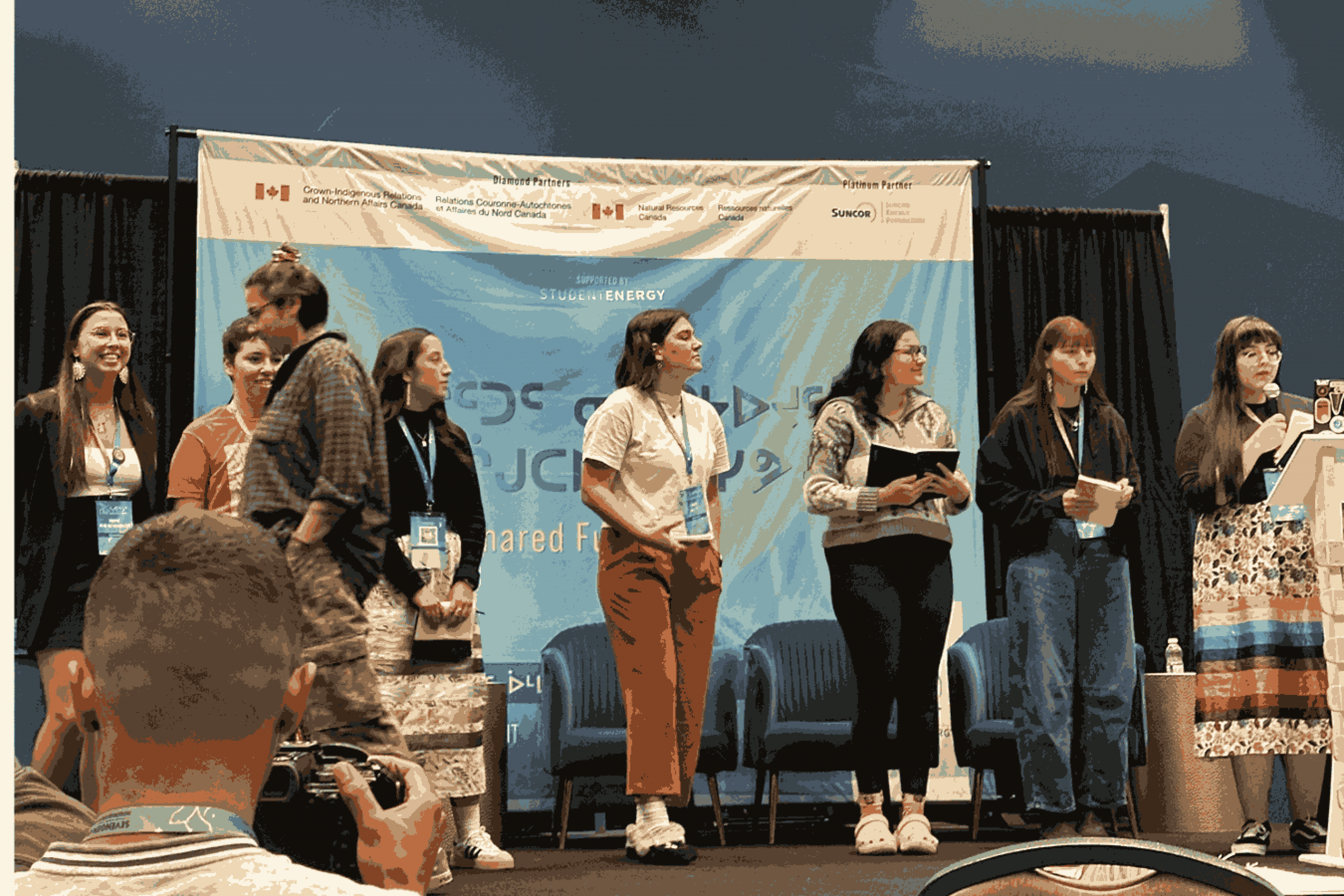 Group of young presenters on stage at the SevenGen Indigenous Youth Energy Summit.